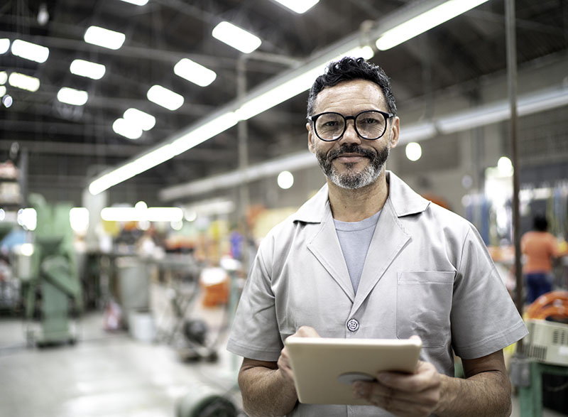 Portrait of an employee using digital tablet in a factory