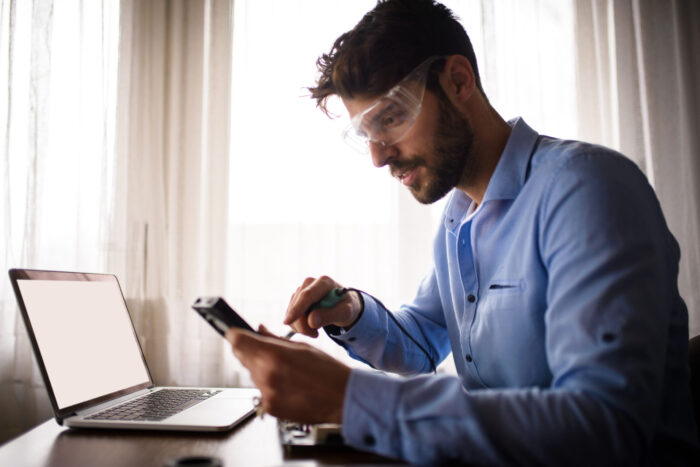 Man repairing computer with online course