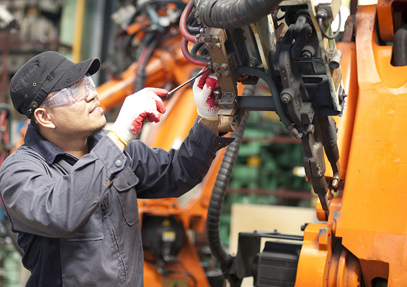 Mechanic repairing a robot machine