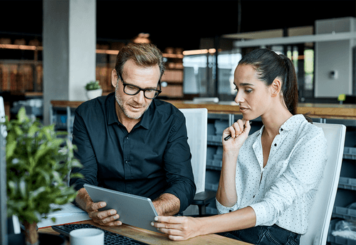 two product designers sharing tablet