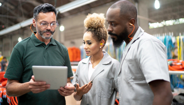 workers looking at an iPad screen