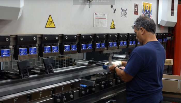 man in front of machine in job shop