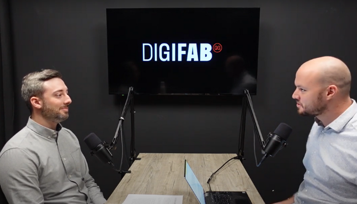 two people in front of microphones with digifab logo behind on a tv